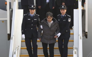 Yang Xiuzhu is escorted from her plane upon arriving in Beijing on Wednesday. Photo: Xinhua