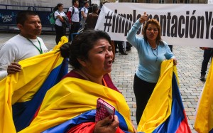 People shout slogans during a demo for the immediate implementation of the agreement between the Colombian government and the Farc guerrillas at Bolivar Square in Bogota. Photo: AFP People shout slogans during a demo for the immediate implementation of the agreement between the Colombian government and the Farc guerrillas at Bolivar Square in Bogota. Photo: AFP