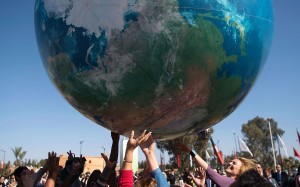 Members of International delegations play with a giant air globe ball outside the COP22 climate conference. Photo: AFP Members of International delegations play with a giant air globe ball outside the COP22 climate conference. Photo: AFP