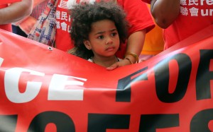 A child holding a banner during a rally in support of World Refugee Day 2016 in Central earlier this year. Photo: Edward Wong