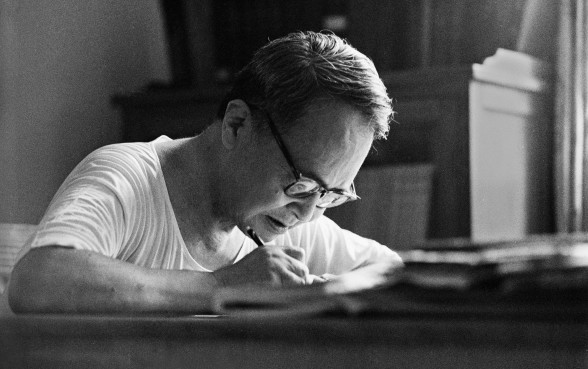 Late Chinese literary scholar and writer Qian Zhongshu writes in his study at home in 1984. Photo: China Foto Press
