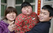 Two-year-old Pang Ya (the Chinese term for fat girl), who weighs 41.5kg, with her parents at home in Yuncheng, Shanxi province. Photos: Corbis