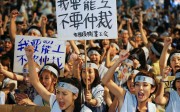 China Airlines flight attendants carry placards and shout slogans on Thursday during a protest outside the airline’s Taipei headquarters in Taipei, which led to a strike from midnight. Photo: EPA
