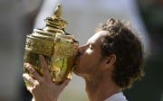 Andy Murray kisses the trophy as he celebrates winning the mens singles final against Canada's Milos Raonic REUTERS/Tony O'Brien