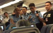Police officers met the flight on arrival at Hong Kong International Airport. Photo: SCMP Pictures