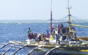 Chinese Coast Guard members, wearing black caps and orange life vests, approach Filipino fishermen as they confront them off Scarborough Shoal at South China Sea in 2015. File photo: AP Chinese Coast Guard members, wearing black caps and orange life vests, approach Filipino fishermen as they confront them off Scarborough Shoal at South China Sea in 2015. File photo: AP