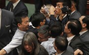 Pan-democrats join the scrum amid scuffles with Legislative Council security guards as they try to prevent Sixtus Leung (centre, holding a piece of paper) from retaking his oath on November 2. Photo: AP Pan-democrats join the scrum amid scuffles with Legislative Council security guards as they try to prevent Sixtus Leung (centre, holding a piece of paper) from retaking his oath on November 2. Photo: AP
