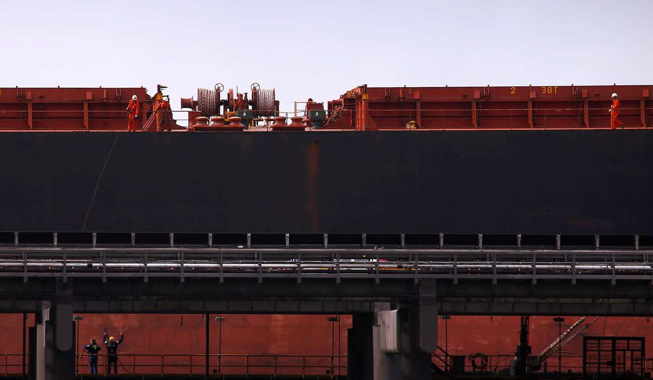 Port workers load a ship with coal at the RG Tanna Coal Terminal at the town of Gladstone in Queensland, Australia. Photo: Reuters