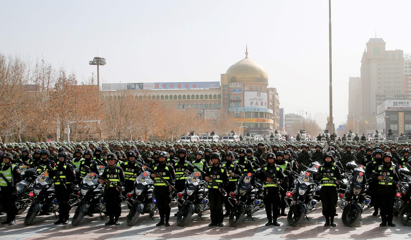 Police attend an anti-terrorist oath-taking rally in Hetian, Xinjiang, in February. Photo: AFP