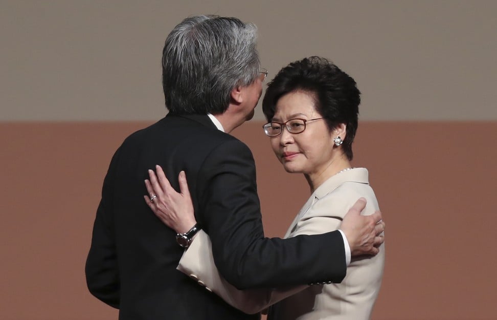 John Tsang(L) and Carrie Lam embrace during the result announcement. Photo: Robert Ng