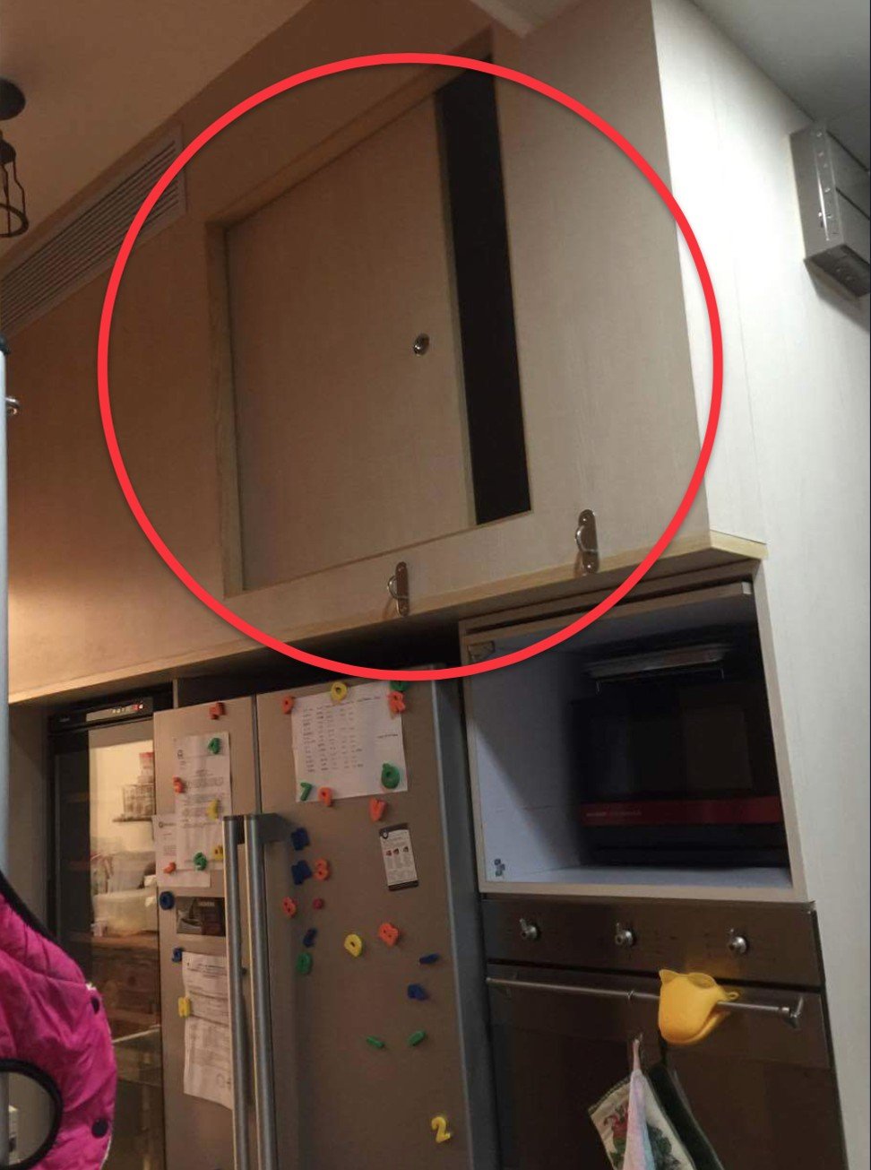 A helper’s bed was fitted into a kitchen cupboard above the fridge and microwave oven. Photo: Handout