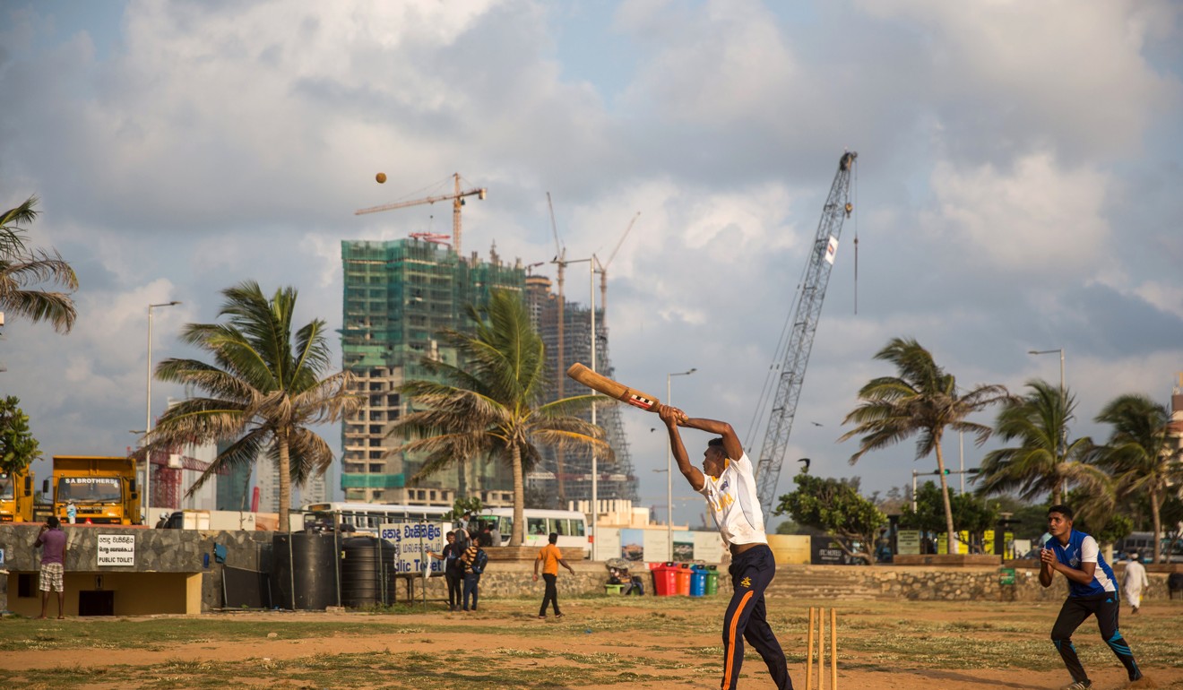 People play cricket with towers under construction in the background in Colombo, Sri Lanka. Photo: Bloomberg