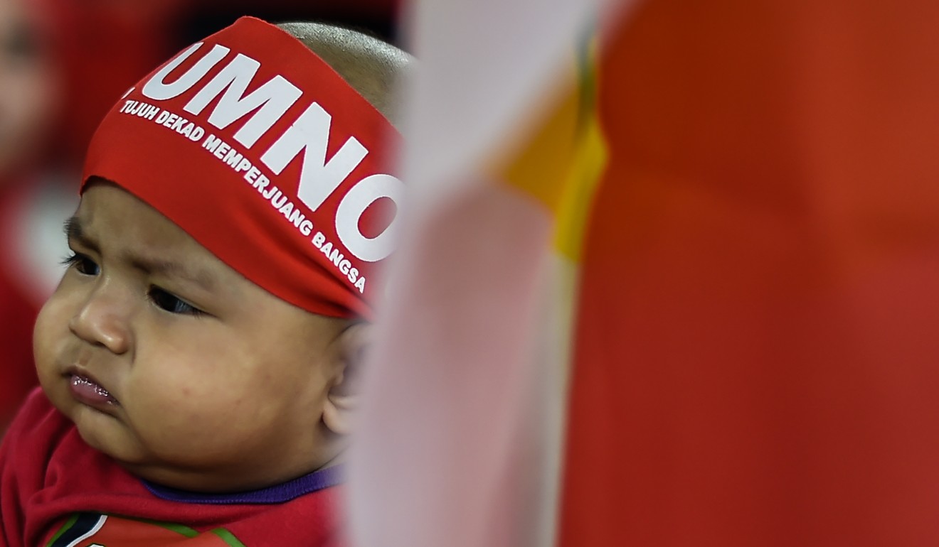 A baby attends the United Malays National Organisation’s 71st anniversary celebration in Bukit Jalil stadium, Malaysia. Photo: AFP