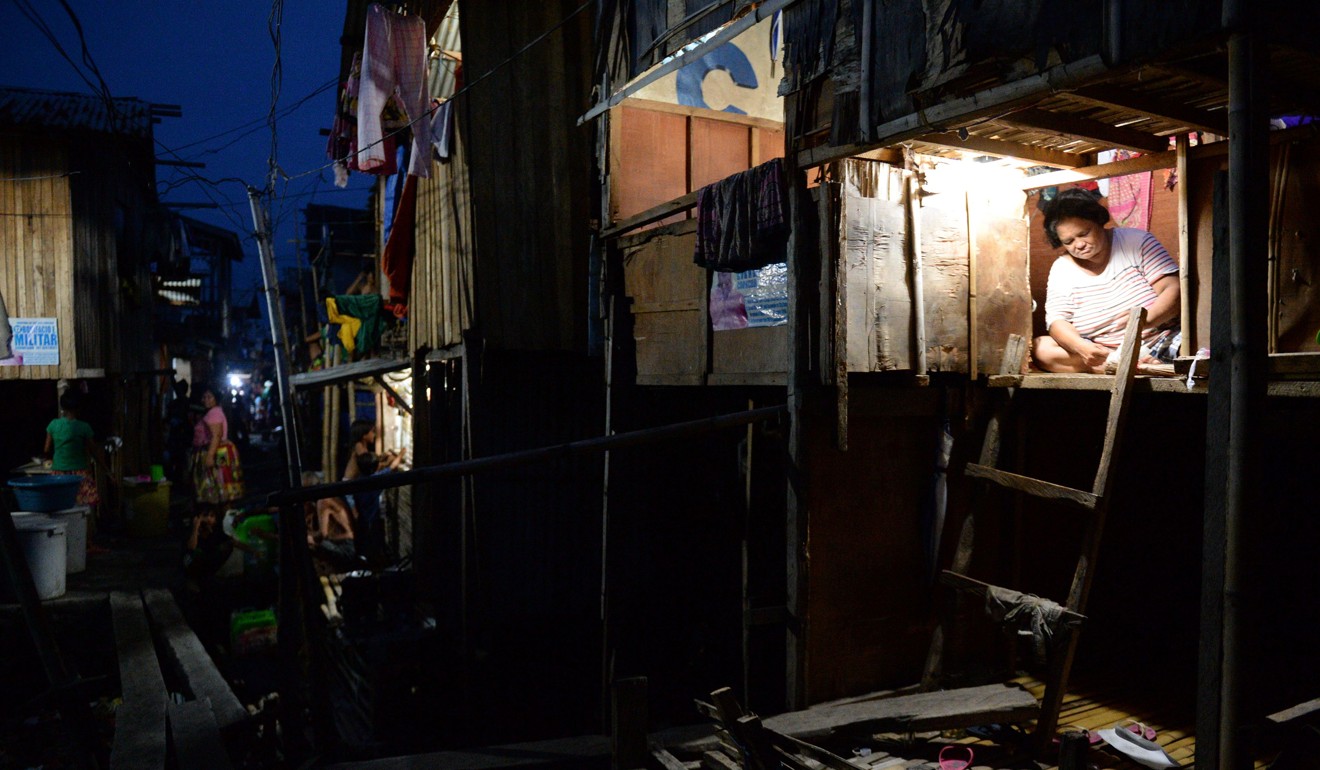 A shanty town in Davao at night. Photo: AFP