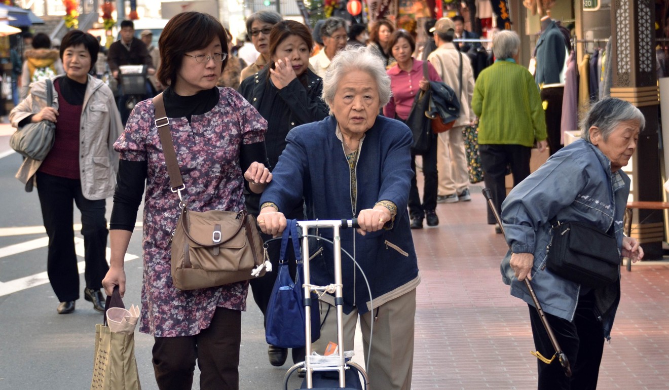 Elderly Japanese stroll down a shopping precinct in Tokyo. Photo: AFP