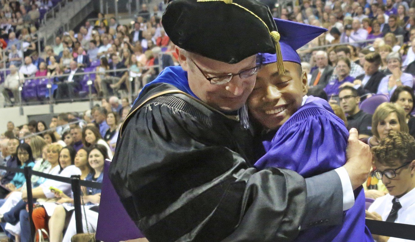 Fourteen year old Carson Huey-You gets a hug from his mentor, physics professor Magnus Rittby, after receiving a bachelor's degree in physics at the Texas Christian University commencement held in Fort Worth on Saturday. Photo: AP