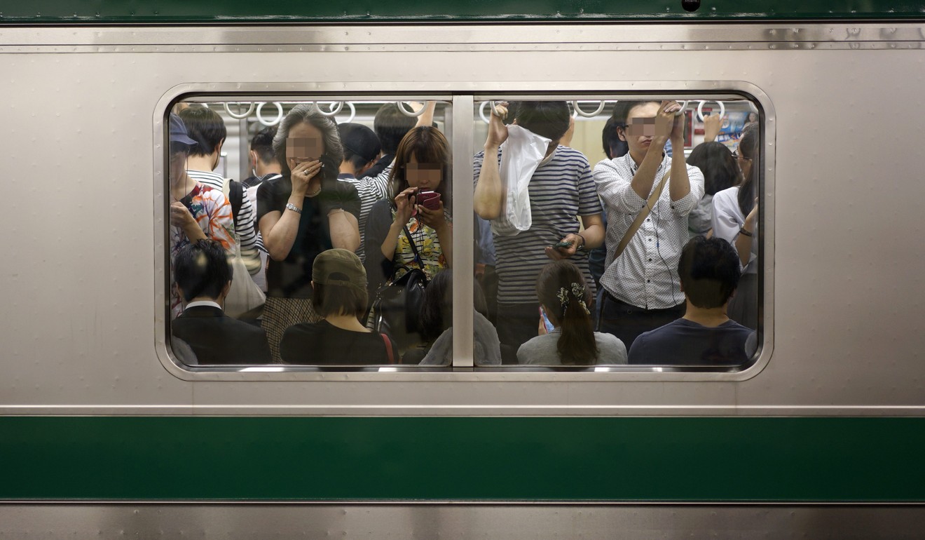 A crowded train at Ikebukuro Station in Tokyo area. Photo: EPA