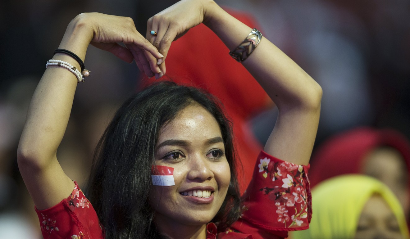 An Indonesian migrant worker in Hong Kong shows her affection for visiting Indonesian President Joko Widodo (not pictured) on April 30. Widodo got a hero’s welcome from his compatriots. Photo: EPA