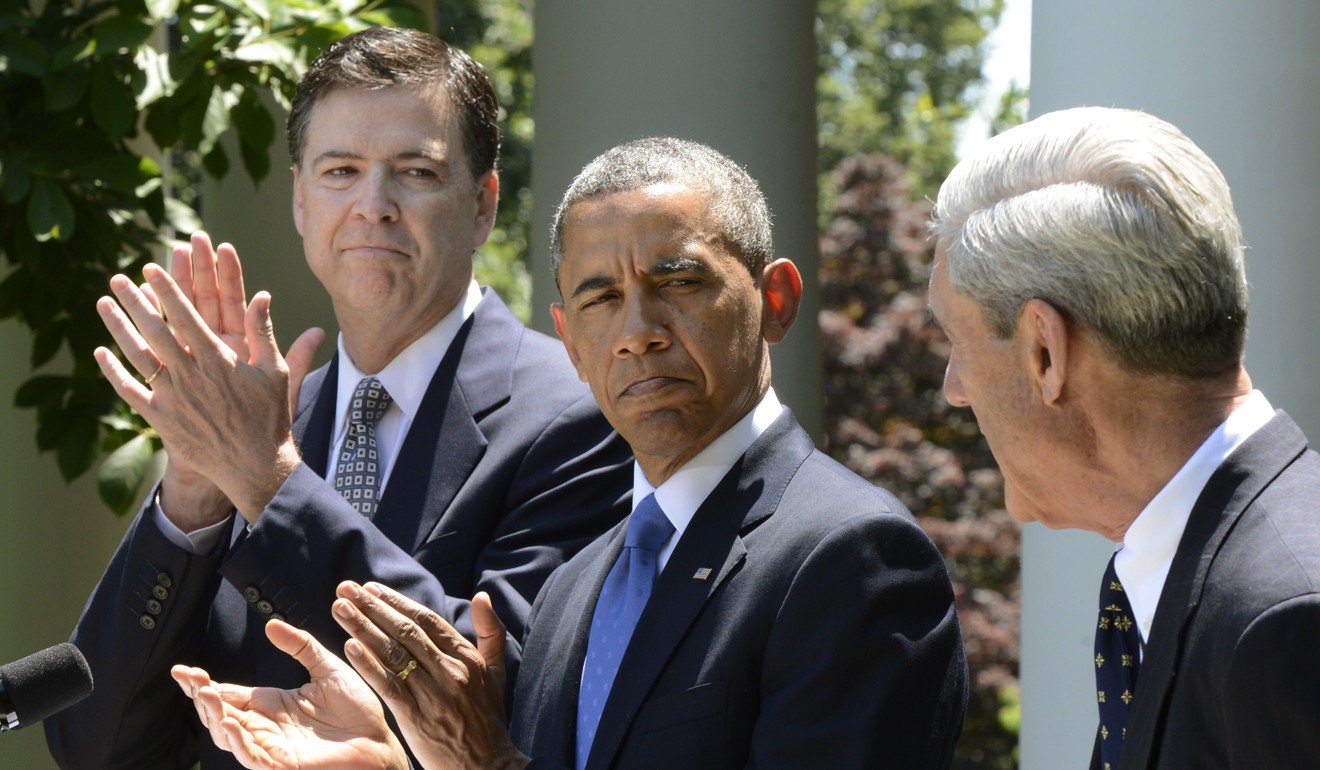 A file picture dated 21 June 2013 shows US President Barack Obama (centre) and James Comey (left) applauding outgoing Federal Bureau of Investigation (FBI) Director Robert Mueller after Obama announced his nomination of Comey to replace Mueller. Photo: EPA