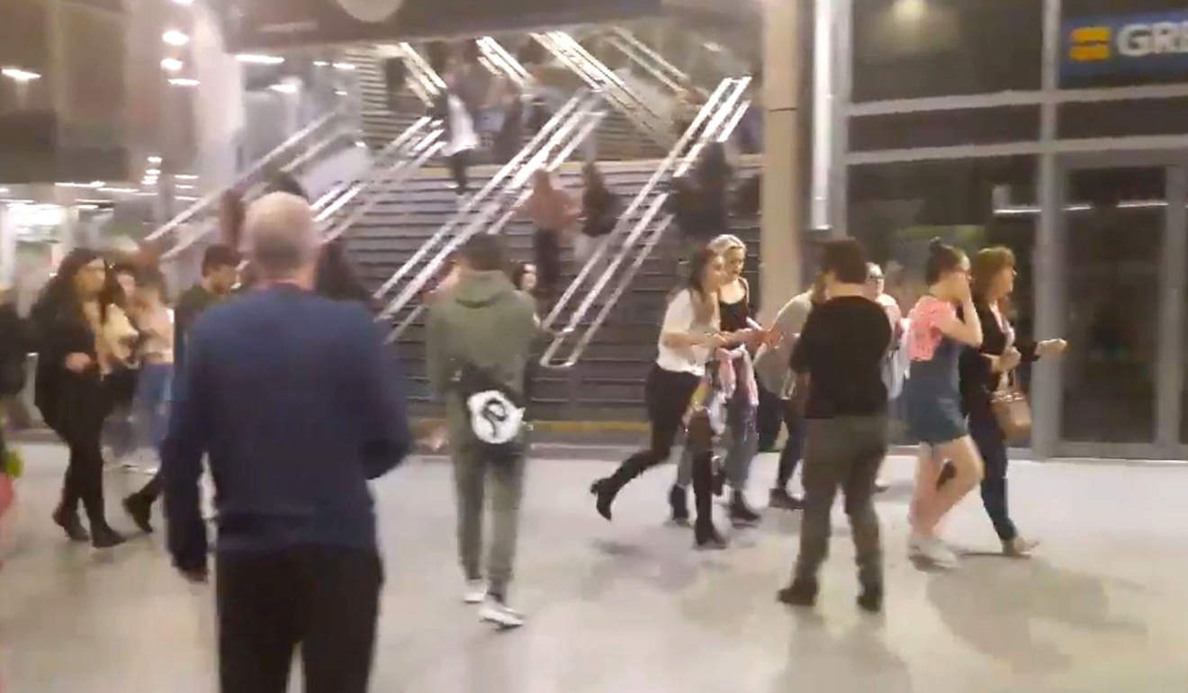 People run through Manchester Victoria station after an explosion at Manchester Arena. Photo: AP