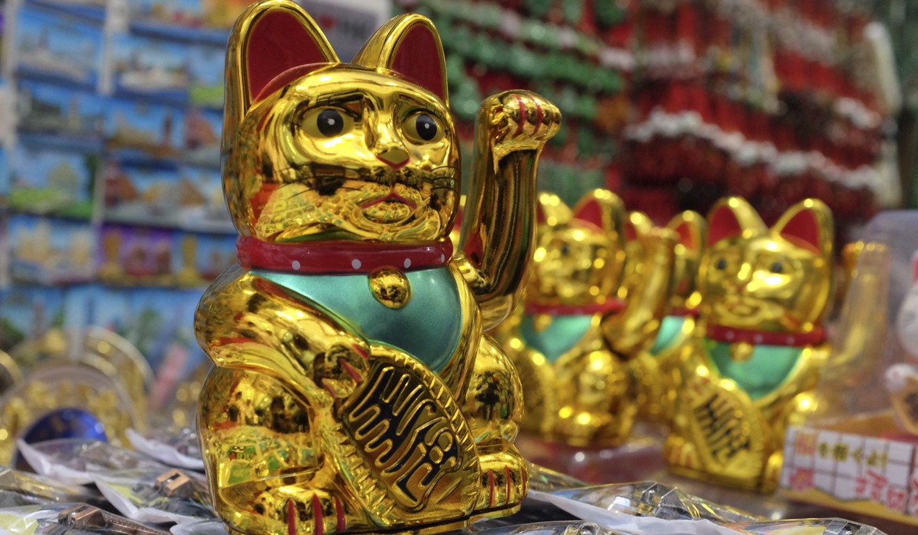 Iconic Japanese gold cats known as maneki-neko can be found at multiple stalls. Photo: Alkira Reinfrank