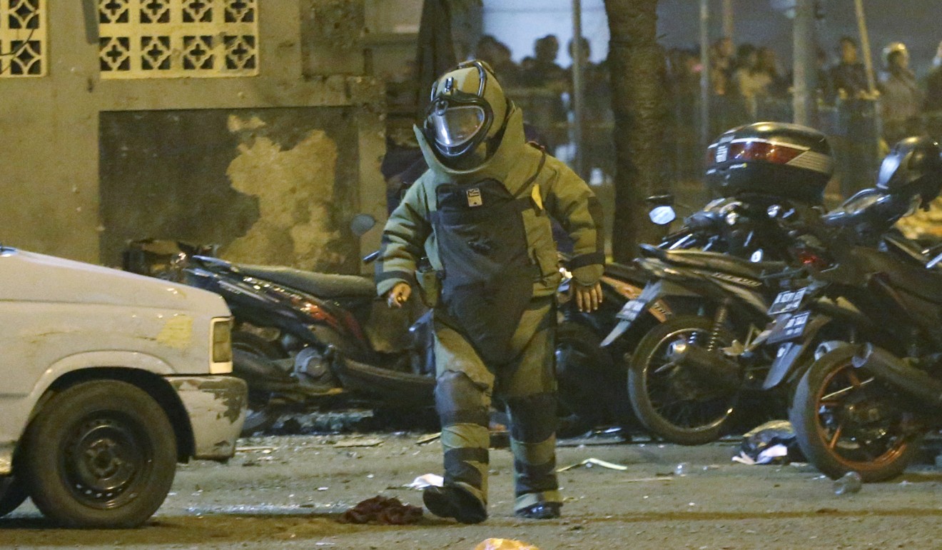 A member of the police bomb squad inspects the site of the explosion. Photo: AP