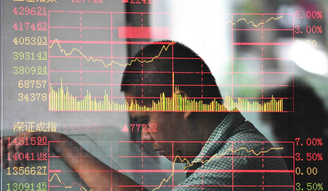 An investor looks through stock information at a trading hall in a securities firm in Haikou, capital of southeast China's Hainan Province, on June 30, 2015. Photo: Xinhua