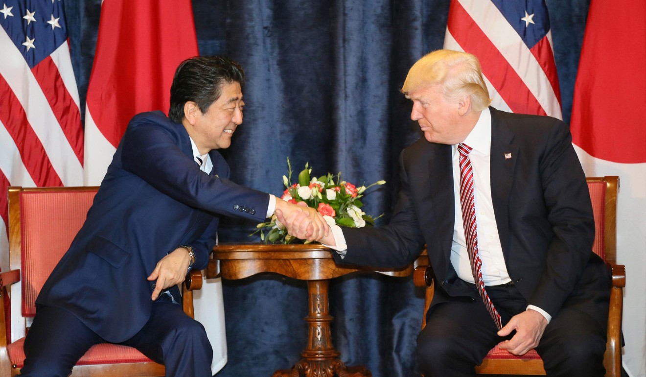 Japanese Prime Minister Shinzo Abe and US President Donald Trump shake hands at the start of their talks in Taormina, Italy, on Friday. Photo: Kyodo
