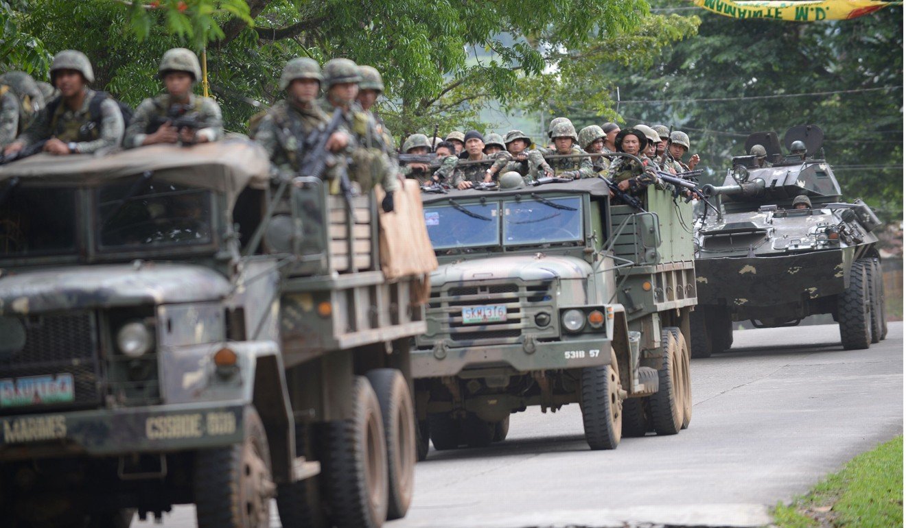 Marines in vehicles on their way to an assault on the hide out of Muslim militants in Marawi. Photo AFP