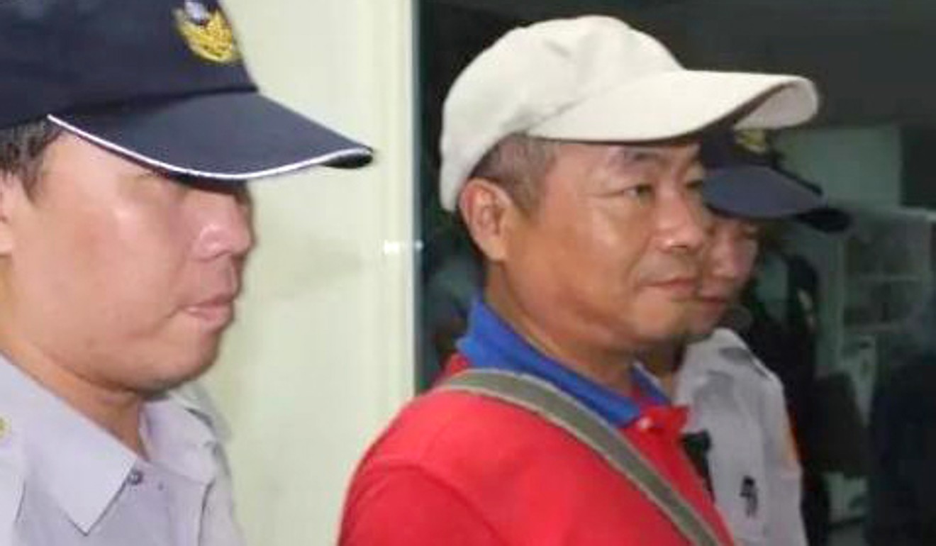 Pro-Beijing activist Lee Cheng-lung (centre), arrested on suspicion of attacking the century-old statues. Photo: Handout