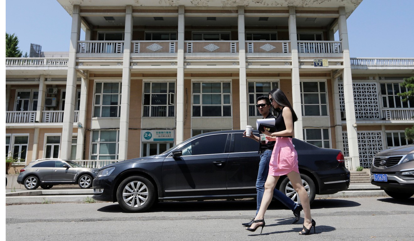 People walk past a branch of China Minsheng Bank in Beijing. Photo: Reuters