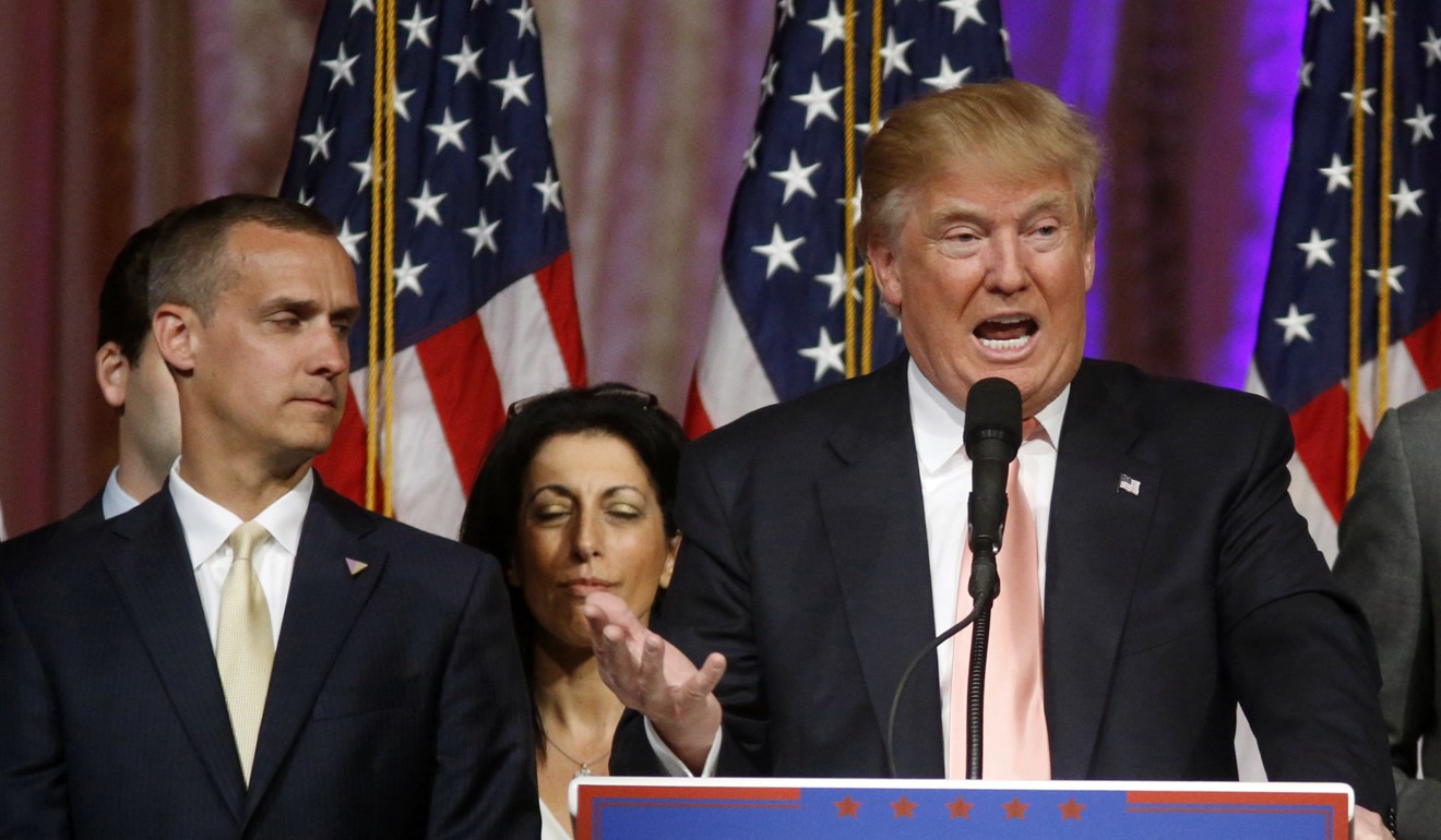 In this March 15, 2016, file photo, then Republican presidential candidate Donald Trump speaks to supporters at a primary election night event at his Mar-a-Lago Club in Palm Beach, Florida, as then campaign manager Corey Lewandowski listens. Photo: AP