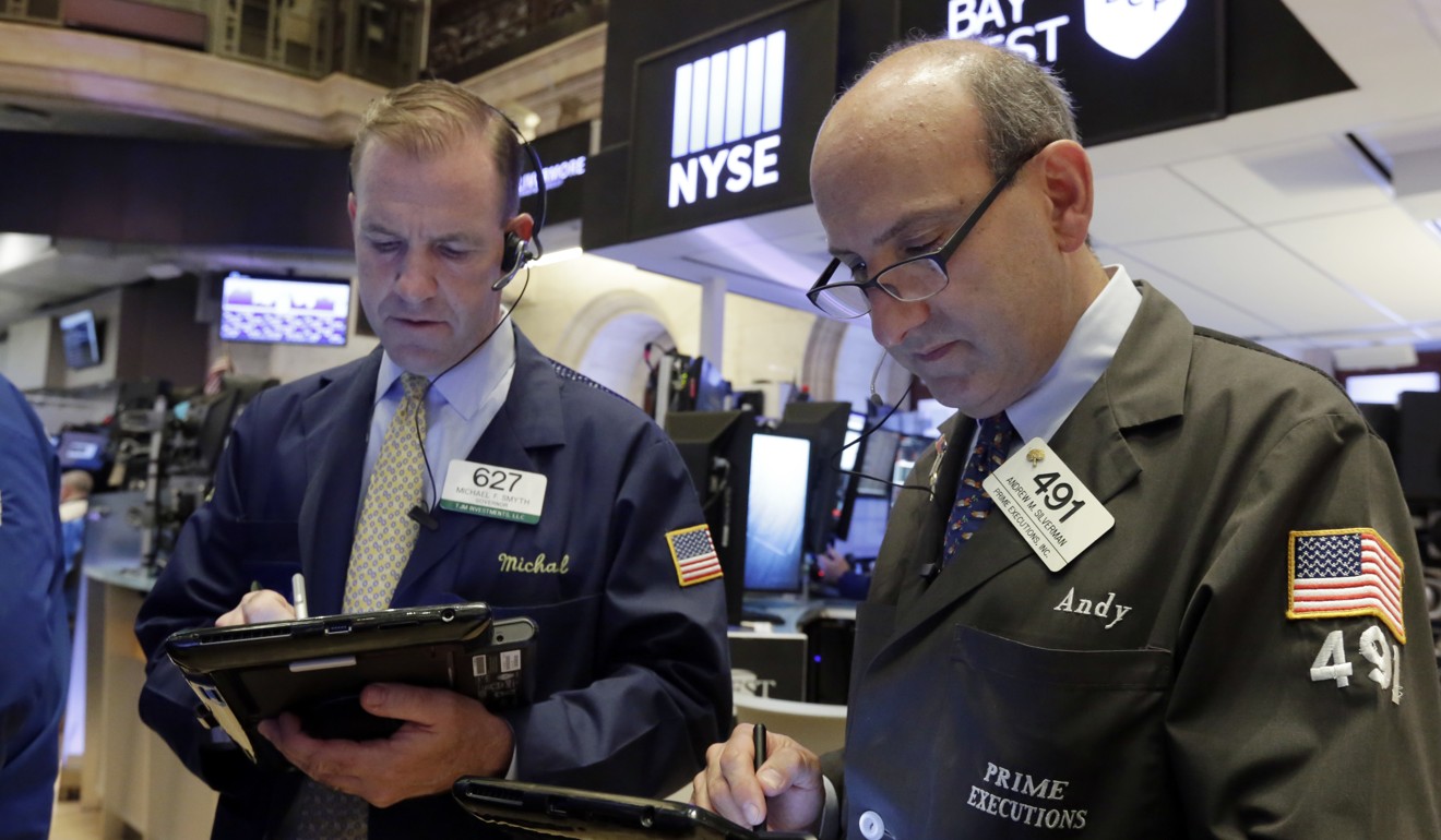 Trader Michael Smyth, left, and Andrew Silverman work on the floor of the New York Stock Exchange. Photo: AP