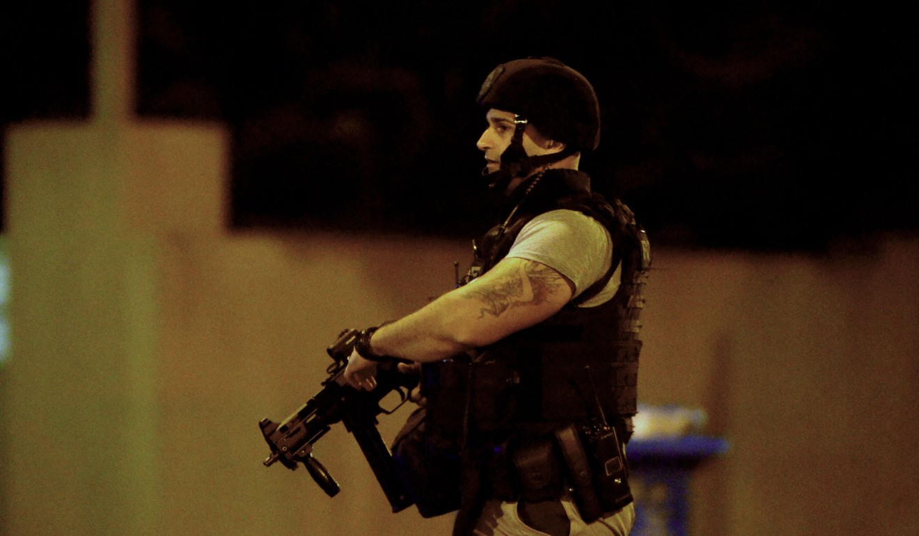An armed police officer at the scene of the siege. Photo: AFP