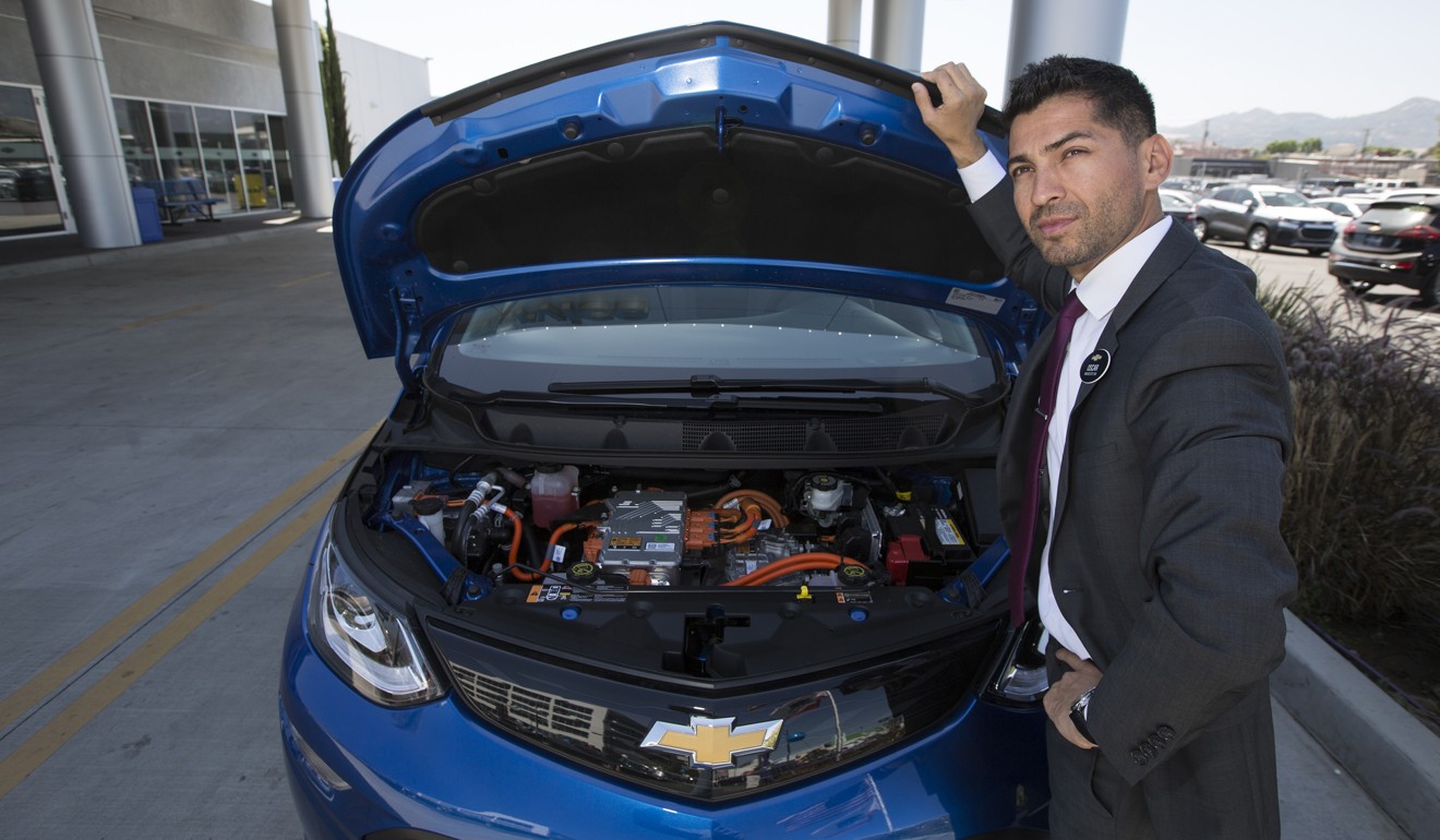 Chevrolet sales manager Oscar Gutierrez with a Bolt EV electric car in Burbank, California. Photo: Los Angeles Times