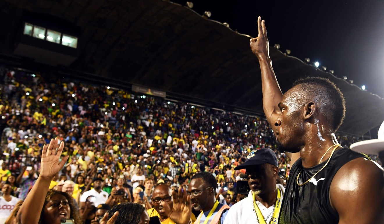Usain Bolt salutes the crowd after running his final race in his home country during the Racers Grand Prix at the national stadium in Kingston, Jamaica. Photo: AFP