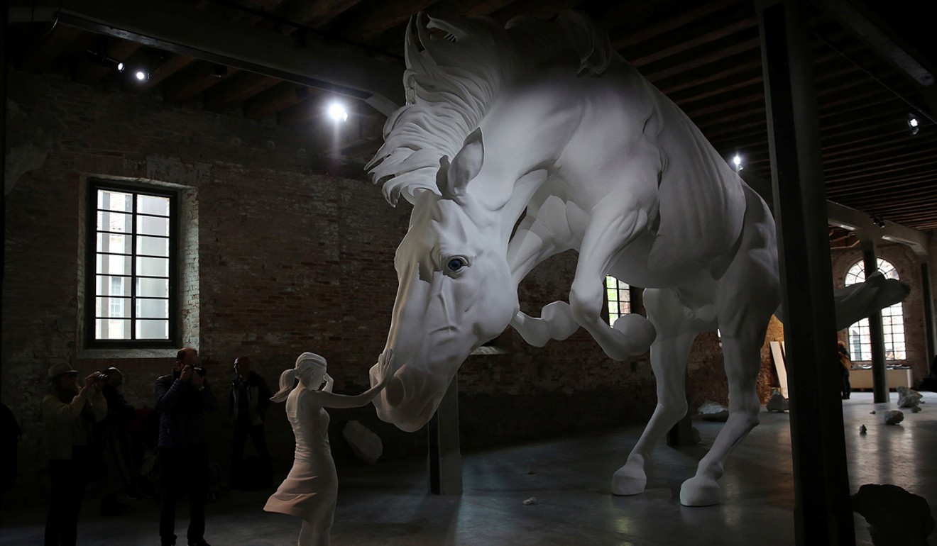 Visitors take pictures at the installation called ‘Horse problem’ by Argentinian artist Claudia Fontes at the Venice Biennale in Italy. Photo: Reuters