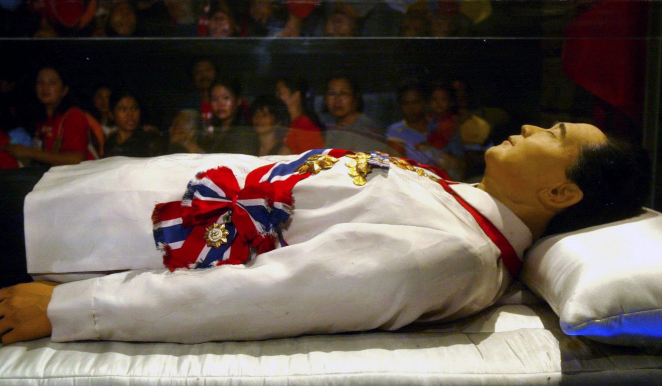 Supporters view the glass crypt containing the body of late Philippine president Ferdinand E. Marcos. Photo: EPA