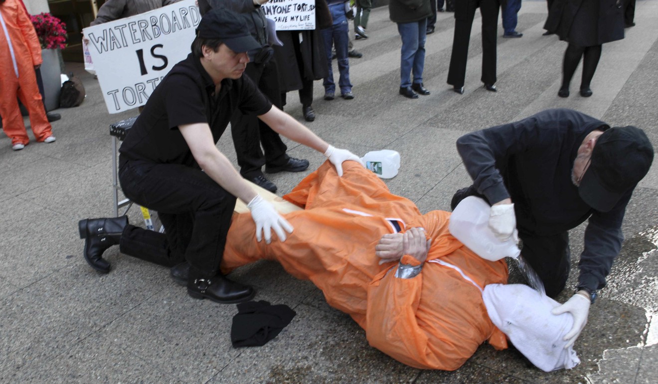 Mike Morice, centre, and other members of World Can't Wait group perform a live waterboarding demonstration outside the Spanish Consulate in Manhattan in 2009. Photo: AP