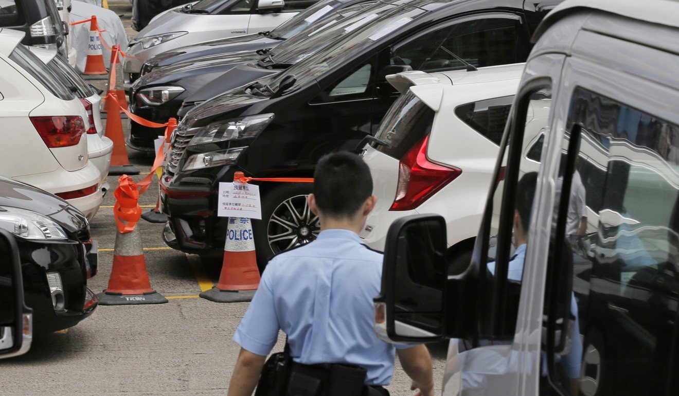 Impounded cars parked at a police station in Hong Kong after a crackdown in May, in which 22 Uber drivers were arrested on suspicion of driving without a hire car permit. Photo: AP