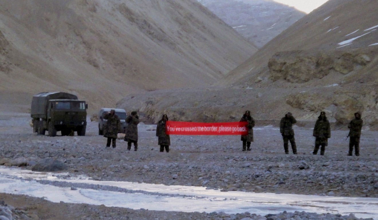 Chinese troops hold a banner that reads: “You've crossed the border, please go back,” in Ladakh, India in this file photo. Tensions between the world’s two most populous nations have once again bubbled over. Photo: AP