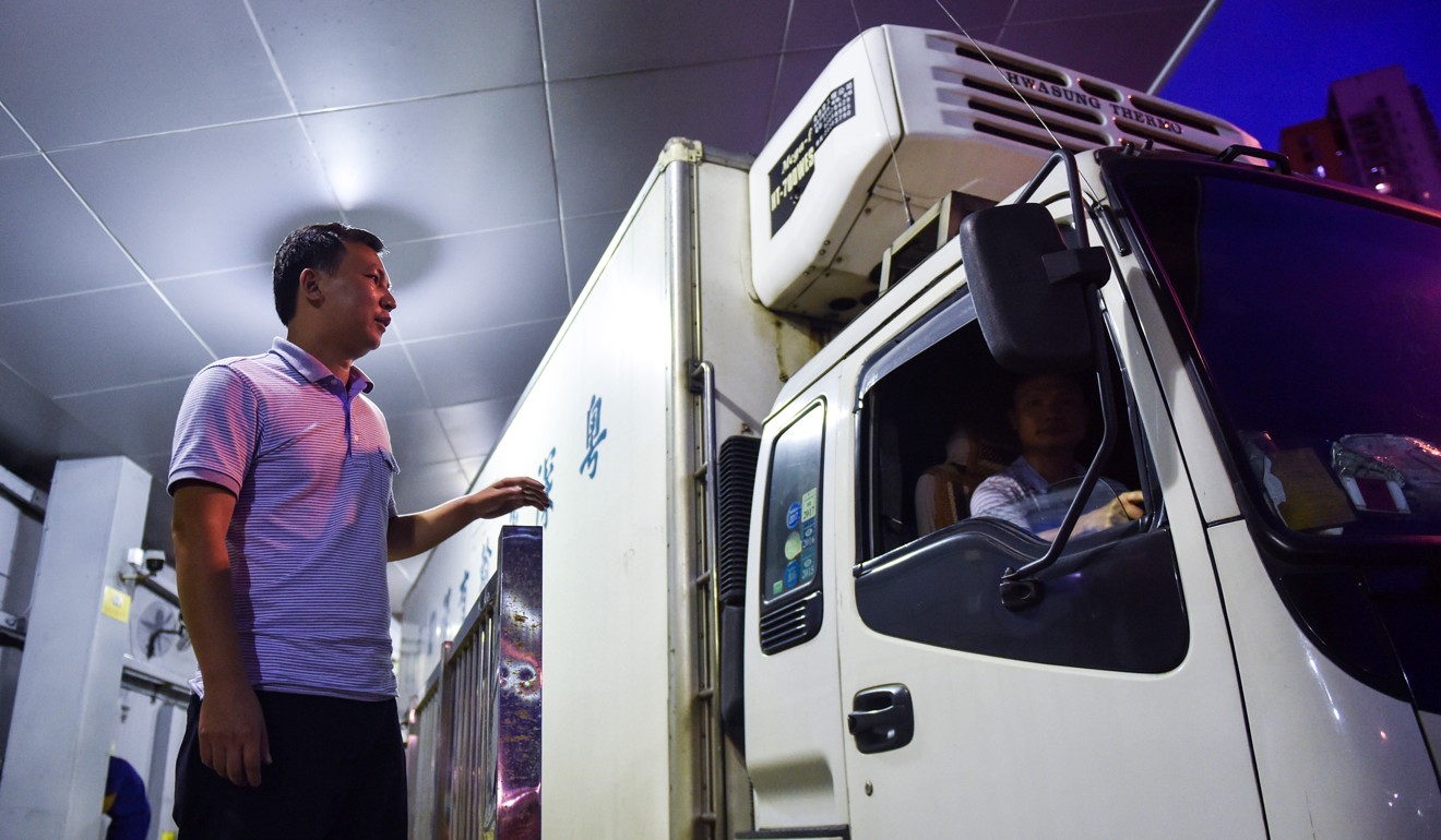 Lorry drivers in Shenzhen changing shift. The cost of living is rising in Shenzhen and, with a decline in port throughput, some workers relying on such trade have lost their jobs. Photo: Xinhua