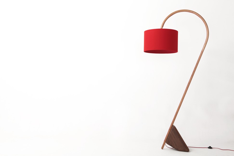 This edgy floor lamp is one of the signature pieces from Elmood and is designed by Giordano Caldarini. Traditional laminated bent solid wood technique was applied to structure the lamp stand with a graceful arc, HK$10,400
