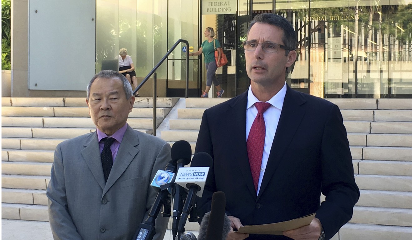 Paul Delacourt, the FBI special agent in charge of the Hawaii bureau, right, speaks at a news conference as Acting United States Attorney Elliot Enoki, left, listens outside federal court in Honolulu on Monday, regarding the case of Ikaika Kang. Photo: AP