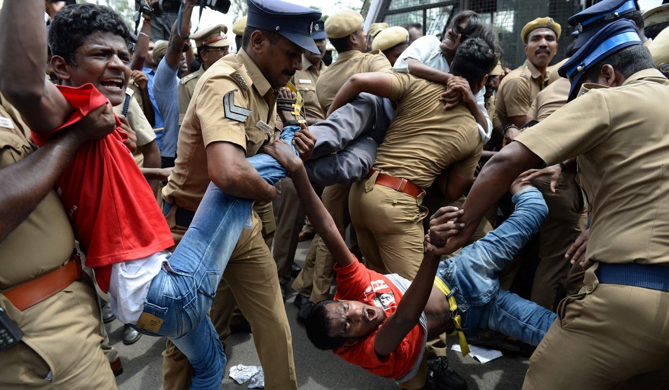 Police removing members of the Revolutionary Students and Youth Front during a protest in Chennai against the ban on the sale of cows for slaughter. Photo: AFP