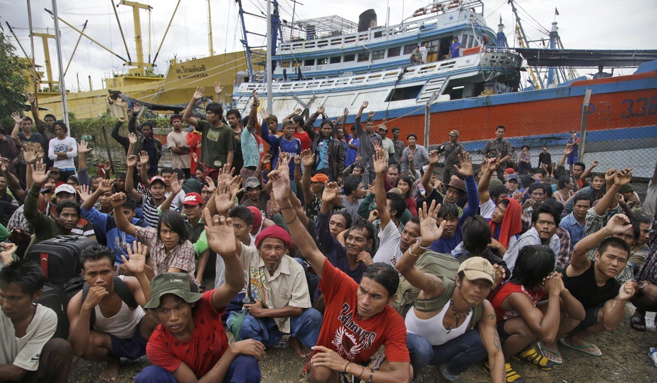 Thai fishing boat crew from Myanmar raise their hands as they are asked who among them wants to go home from Benjina in Indonesia’s Aru Islands in 2015. Photo: AP