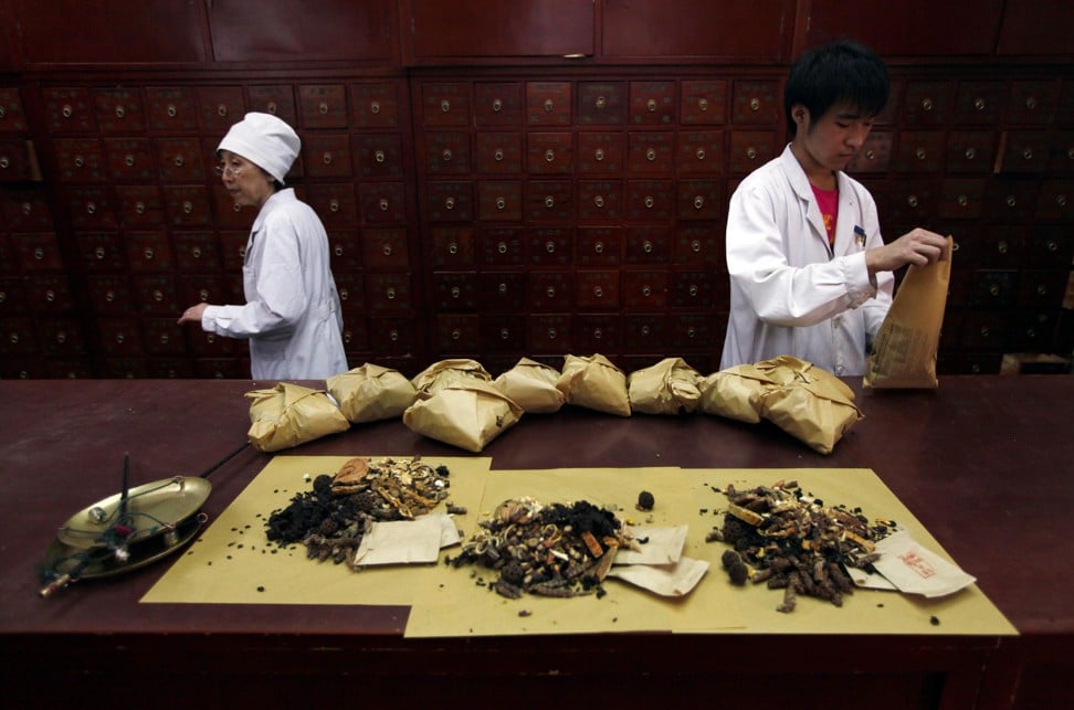 Workers prepare traditional Chinese herbal medicines at Beijing's Capital Medical University Traditional Chinese Medicine Hospital, which distributes around 20,000 prescription doses daily involving more than five tonnes of ingredients. Photo: Reuters