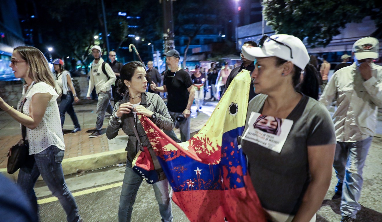 Opposition sympathisers march in Caracas. Photo: EPA