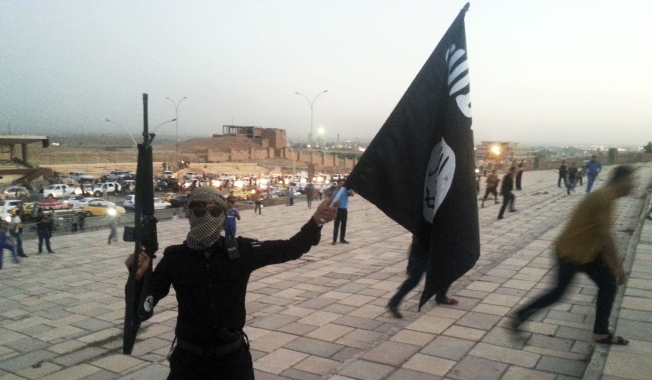 An IS fighter on a street in Mosul, Iraq, in June 2014. Photo: Reuters