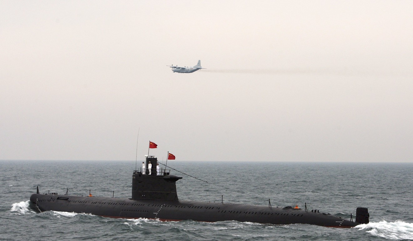 A military aircraft flies past a Chinese Navy submarine at an international fleet review in Qingdao, Shandong province. Photo: Reuters